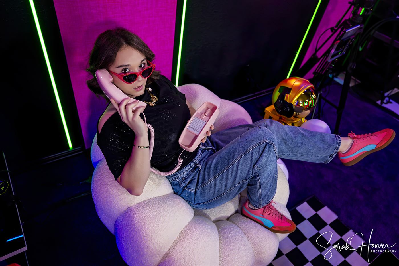 A WAG Podcast host laughing on a retro phone in the studio