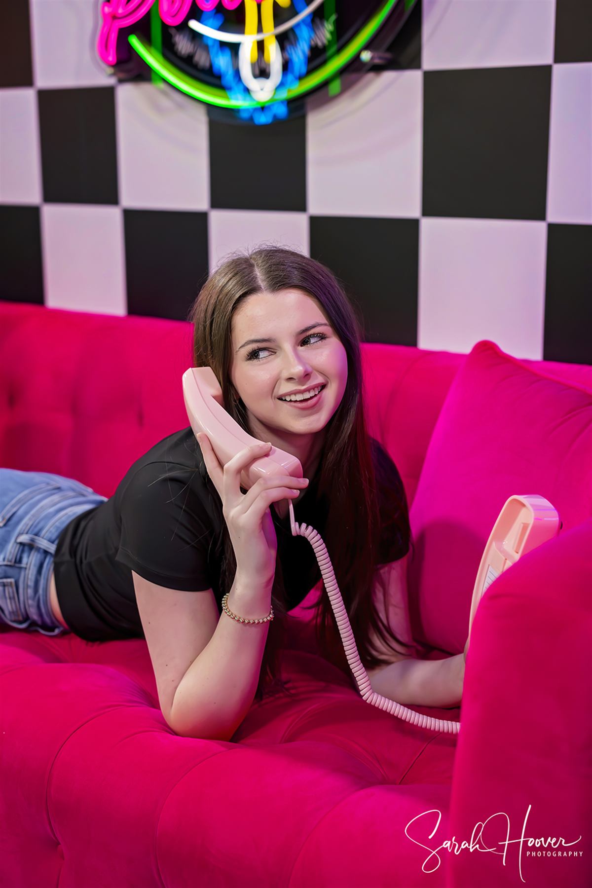 A WAG Podcast host laughing on the phone during a segment