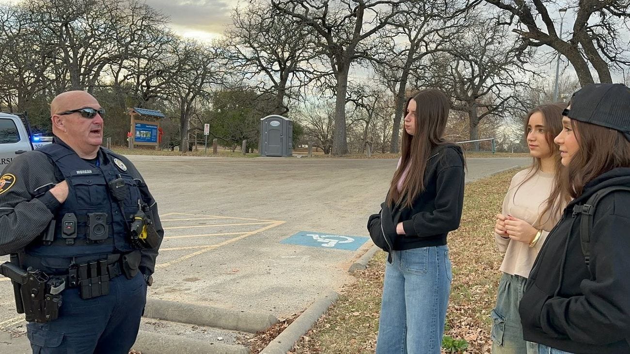 The Wild Adventure Girls talking with a Lake Worth patrol marshal about the Goatman legend in Fort Worth, Texas