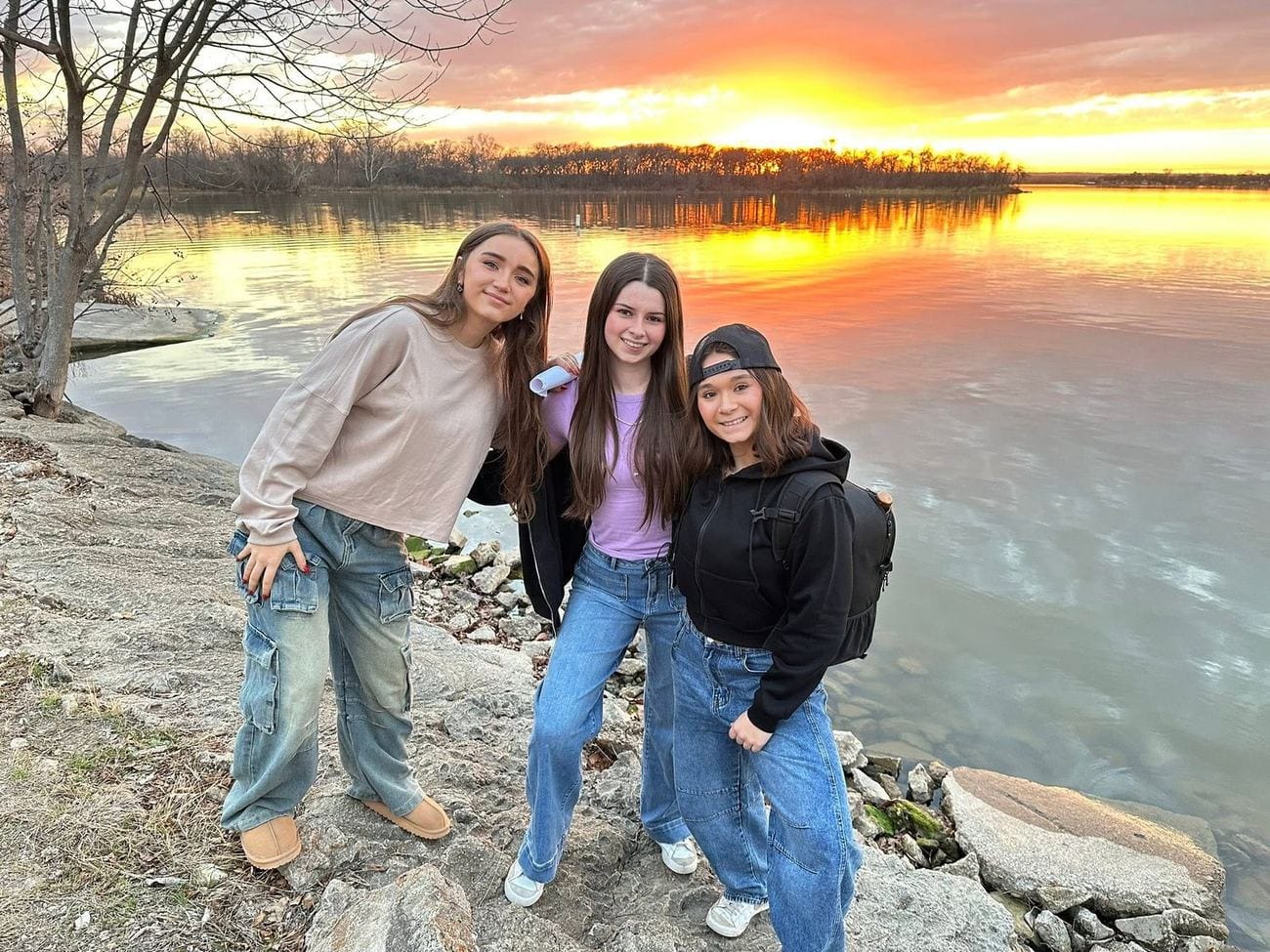 Angelina, Scarlett, and Annabella at sunset on the shore of Lake Worth, Texas, during their Goatman investigation